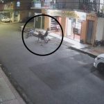Câmera de segurança captura cena de um ataque a tiros em Manaus, mostrando um homem caído no chão e uma motocicleta próxima.