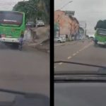 Dois ciclistas andam lado a lado, um deles em frente a um ônibus em movimento, na avenida dos Franceses em Manaus.