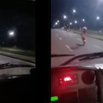 Motociclista em alta velocidade em uma avenida à noite, realizando uma manobra arriscada e perigosa, colocando em risco sua vida e a segurança dos outros motoristas.