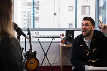 Professor de violão da Oficina Escola de Lutheria da Amazônia (OELA) durante aula com estudante em Manaus.