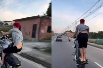 Um motociclista em Manaus realiza uma manobra perigosa em uma via pública, colocando em risco sua segurança e a de outros motoristas.