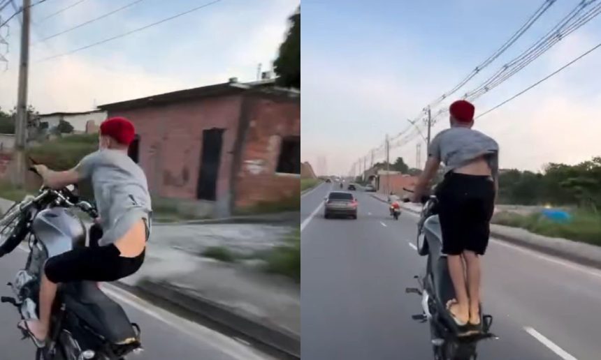 Um motociclista em Manaus realiza uma manobra perigosa em uma via pública, colocando em risco sua segurança e a de outros motoristas.