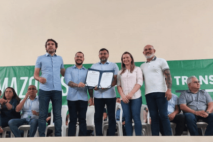 Imagem mostra governador Wilson Lima assinando termo com demais autoridades