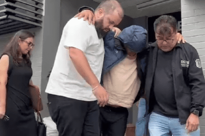 Imagem colorida mostra suspeito sendo preso