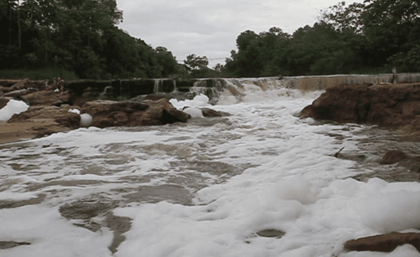 Imagem colorida mostra foto do Igarapé do Tarumã em 2016 coberto de espuma