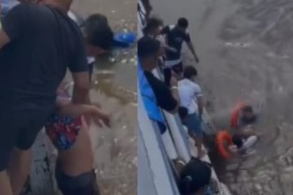 Imagem colorida mostra homem que pulou de barco sendo resgatado