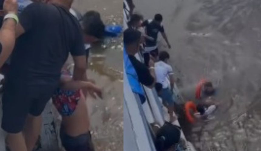 Imagem colorida mostra homem que pulou de barco sendo resgatado