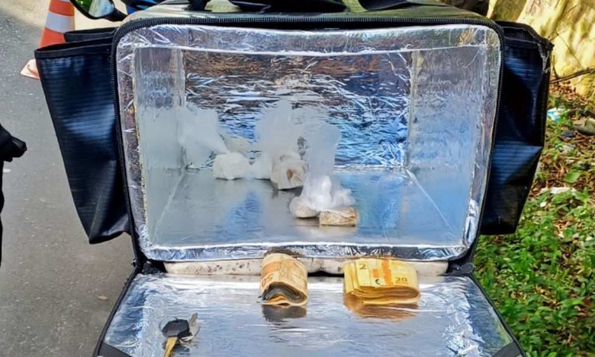 Bolsa térmica de entrega com dinheiro e drogas apreendidas.