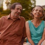 Casal sorrindo em ambiente externo, em um pôr do sol, em um dos filmes do Festival Close.