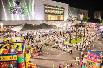Evento gastronômico 'Arraial Chefs de Ponta' em frente ao Shopping Ponta Negra em Manaus, com barracas de comida e diversão.