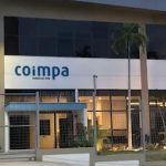 Fachada da Coimpa Industrial Ltda em Manaus, com céu nublado.