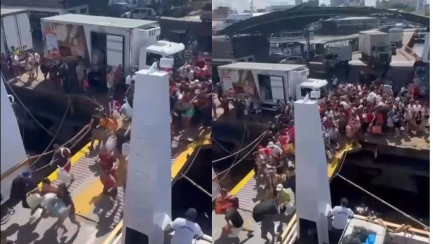 Grande fluxo de pessoas desembarcando de navio no Porto de Manaus, com caminhões ao fundo.