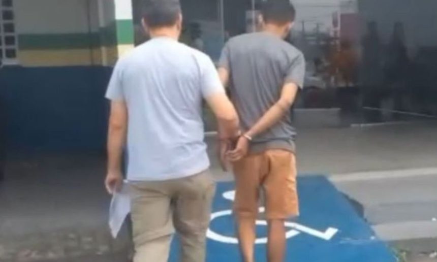 Homem preso sendo escoltado por policial