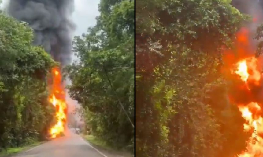 Incêndio em caminhão-tanque na BR-174 após tombamento, com chamas e fumaça densa.