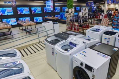 Interior de loja Casas Bahia com lava-roupas e eletrônicos em exposição.