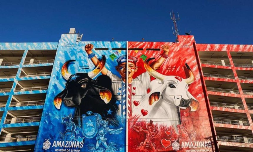 Mural colorido em edifício com bois e figuras festivas, representando o Festival de Parintins.