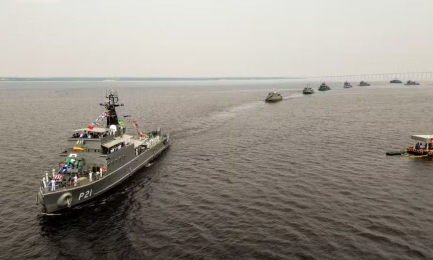 Navios da Marinha do Brasil navegando em formação no rio em Manaus.