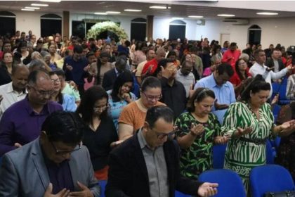 Pessoas em oração em igreja evangélica no Amazonas.