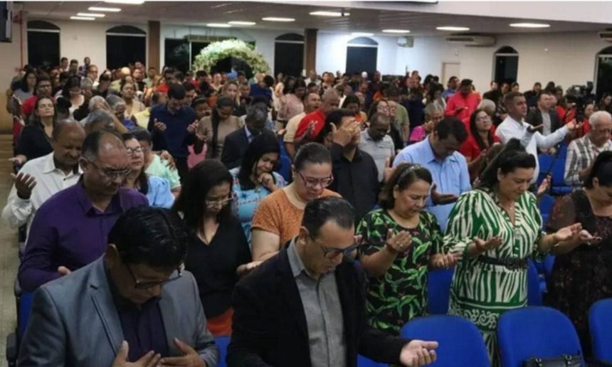 Pessoas em oração em igreja evangélica no Amazonas.