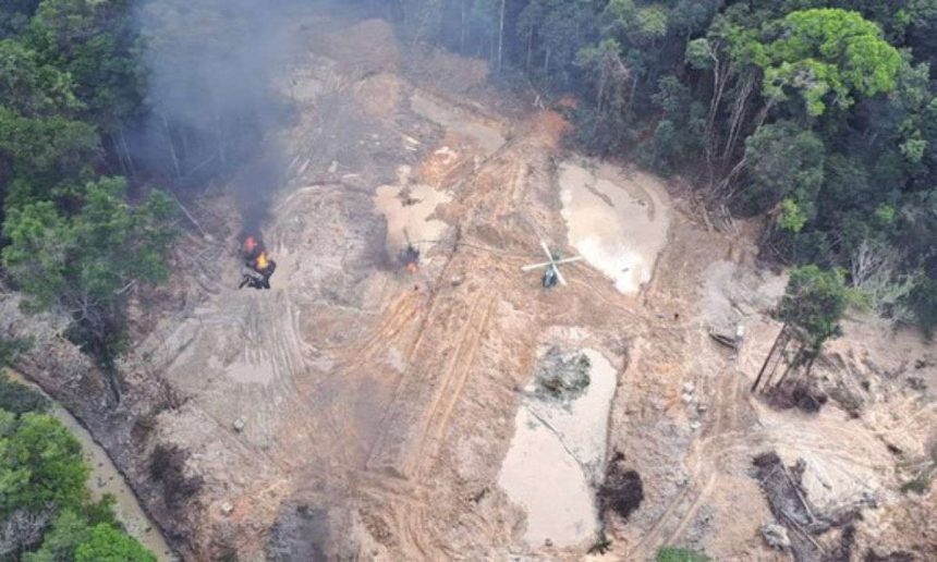 Ação de combate ao garimpo ilegal em área de floresta, com helicóptero e fogo.