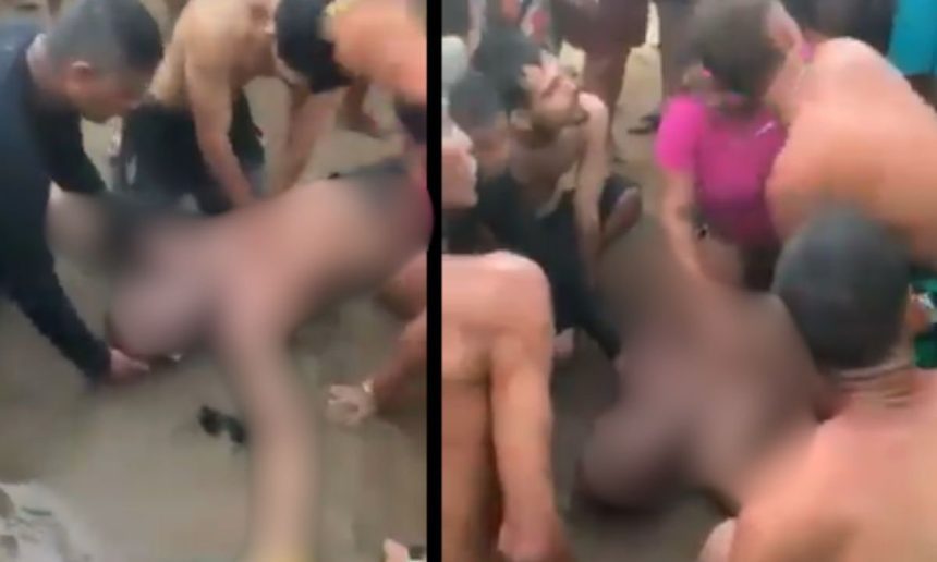 Homem sendo socorrido na praia, possivelmente vÃtima de afogamento.