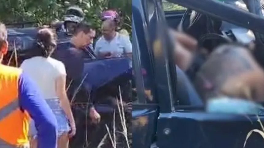 Pessoas reunidas perto de um veículo danificado. Cena possivelmente de acidente.