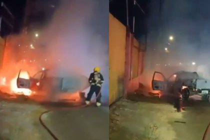 Carro em chamas após explosão em Manaus, bombeiro combatendo o fogo.