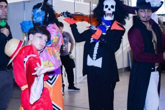 Cosplayers caracterizados como personagens do anime One Piece em evento de cultura japonesa.