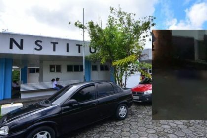 Fachada do instituto com carros estacionados na frente.