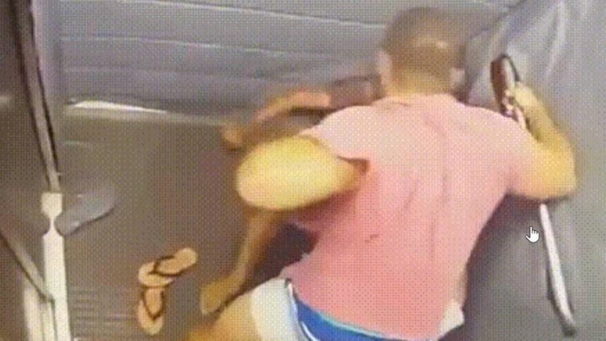 Homem em camisa rosa agrediu outra pessoa em espaço interno.