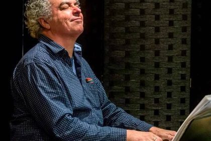 Homem tocando piano com olhos fechados no Amazonas Green Jazz Festival.