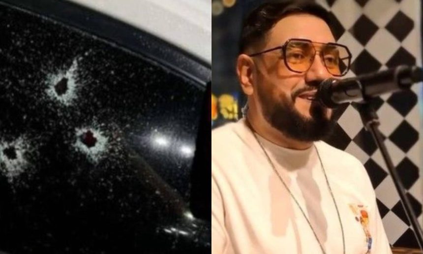 Janela de carro com marcas de tiros e cantor Dubarranco no palco.