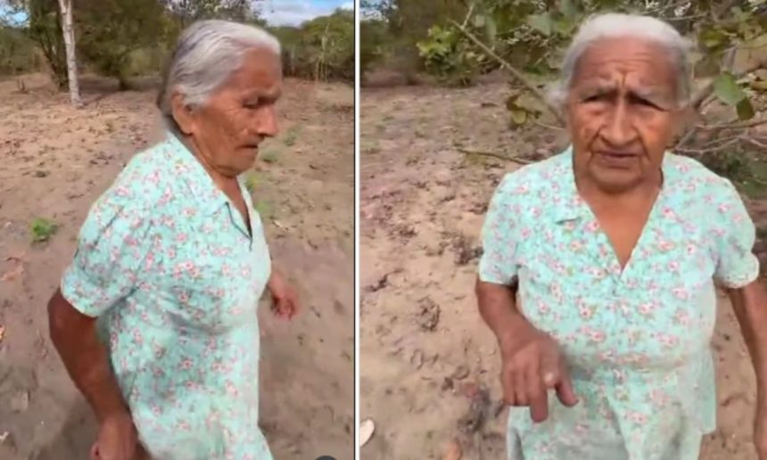 Joaninha, idosa de 90 anos, em vídeo viral, com camisa florida e expressão séria.