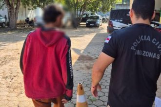 Jovem preso em Lábrea sendo escoltado por policial civil.