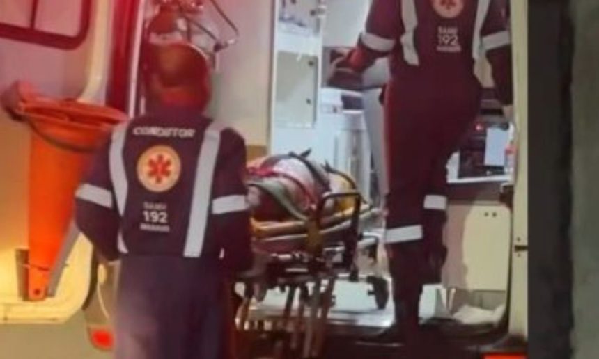 Mulher em maca sendo socorrida por equipe do SAMU dentro de ambulância.