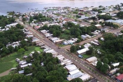 Vista aérea de cidade Fonte Boa com casas, vegetação densa e rio ao fundo
