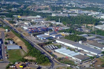 Vista aérea de uma área industrial com contêineres e edifícios.