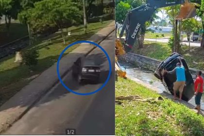 Carro sendo retirado de igarapé por retroescavadeira após acidente