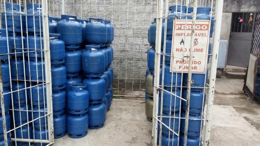 Depósito de botijões de gás azul com sinalização de perigo e proibição de fumar.