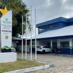 Fachada da Delegacia Integrativa de Polícia (DIP) em Parintins, Amazonas, com carros estacionados.