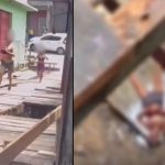 Mulher sendo atacada e jogada em buraco durante briga em ponte de madeira.
