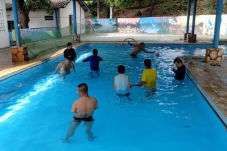 Pessoas com autismo em piscina, participando de projeto esportivo da Apae em Manaus