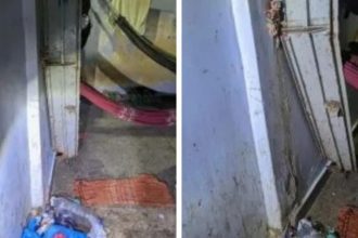 Portão de ferro danificado em cena de fuga de presos.