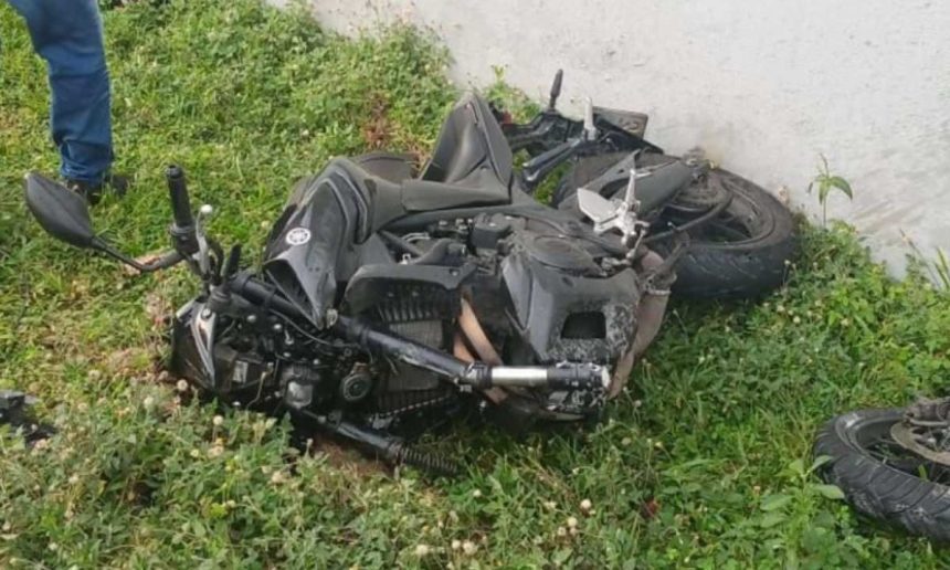 Acidente de moto na Avenida das Torres, com a moto danificada em meio à grama, próximo a um muro.