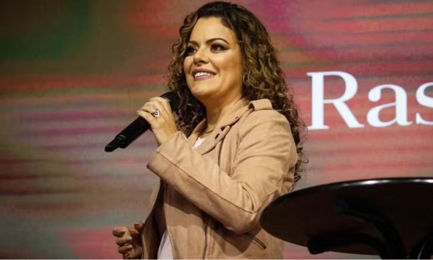 Ana Paula Valadão cantando com microfone em evento gospel.