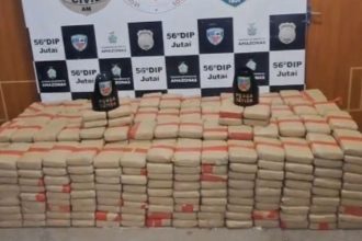Apreensão de drogas pela polícia, mostrando diversos pacotes empilhados