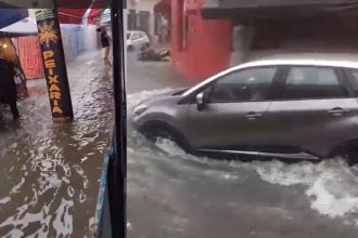 Chuvas fortes causam alagamento em ruas do Centro de Manaus, com carro passando pela água.