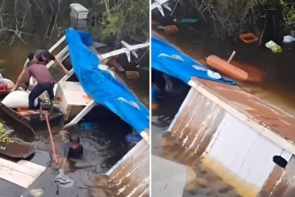 Embarcação naufragada durante temporal no Lago de Coari, com pessoas tentando resgatar pertences.
