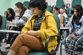 Estudantes em sala de aula, possivelmente aguardando vestibular.