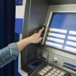 Pessoa usando caixa eletrônico para pagamentos do PIS/Pasep